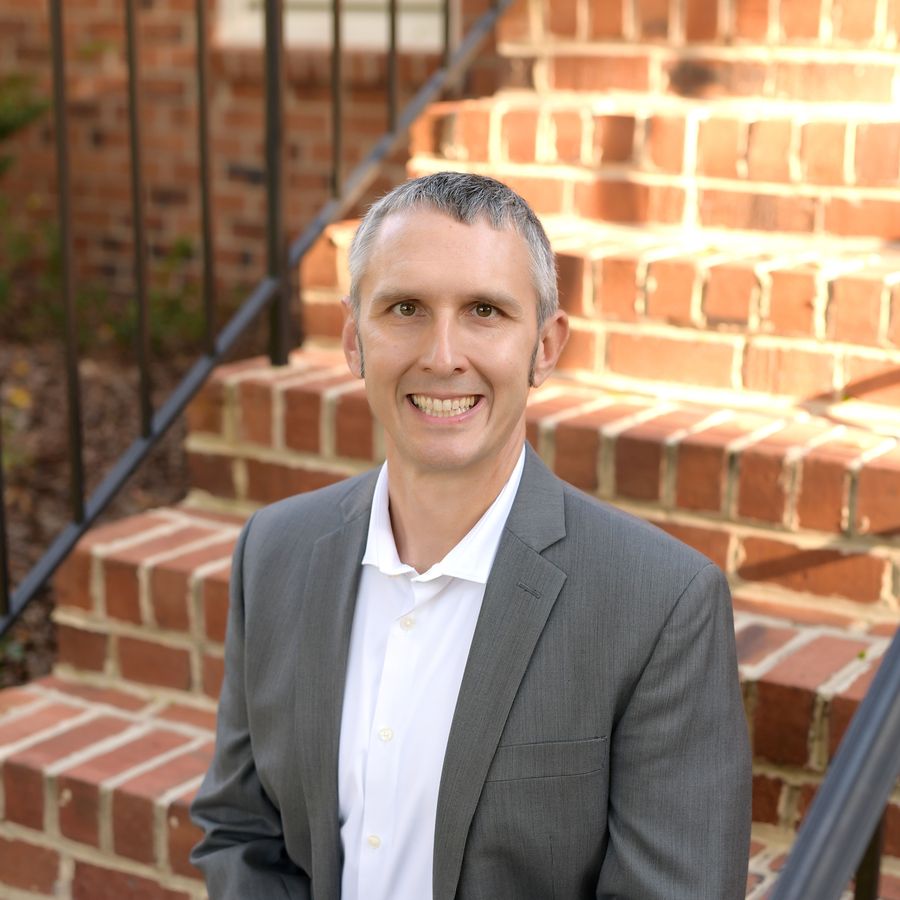 Chris Stahl, Richmond REALTOR, standing on brick steps